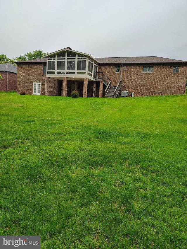 1412 Albert Dr, Bowie, MD 20721 - back of house with brick siding, stairs, a sunroom, and a yard