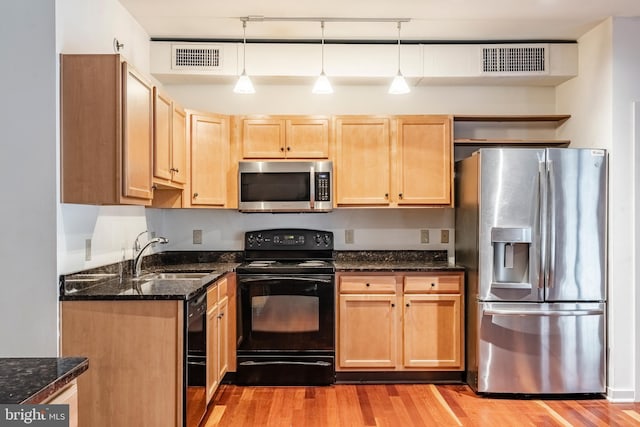 11 W 2nd St Unit 130, Bethlehem, PA 18015 - kitchen with black appliances, light wood-type flooring, a sink, light brown cabinets, and dark stone counters