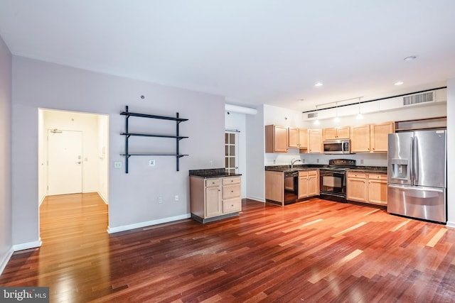 11 W 2nd St Unit 130, Bethlehem, PA 18015 - kitchen featuring black appliances, dark countertops, light brown cabinets, hardwood / wood-style flooring, and baseboards