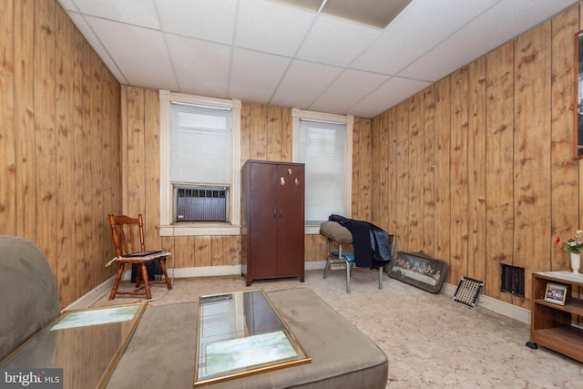 113 N Highland Ave, Baltimore, MD 21224 - living area featuring baseboards, wooden walls, a drop ceiling, and cooling unit