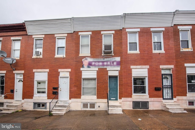 113 N Highland Ave, Baltimore, MD 21224 - view of property featuring entry steps, brick siding, and cooling unit