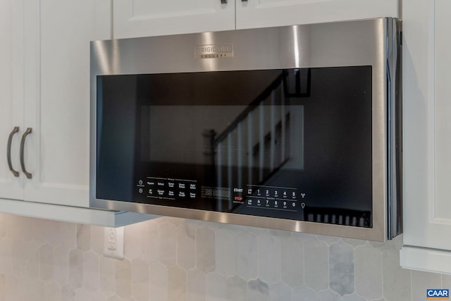 80A Park Ridge Dr, Crozet, VA 22932 - kitchen view of white cabinetry, stainless steel microwave, and tasteful backsplash