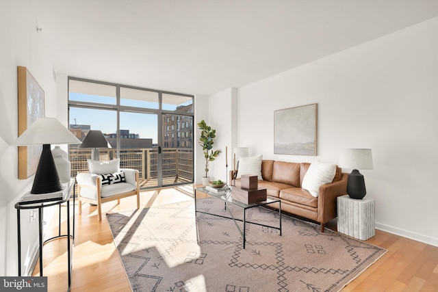475 K St NW Unit 906, Washington, DC 20001 - living area with expansive windows, wood finished floors, and baseboards