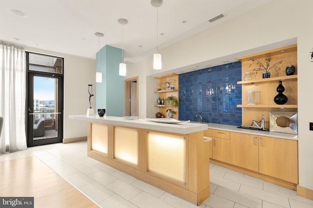 475 K St NW Unit 906, Washington, DC 20001 - kitchen with open shelves, light brown cabinetry, a sink, backsplash, and light countertops