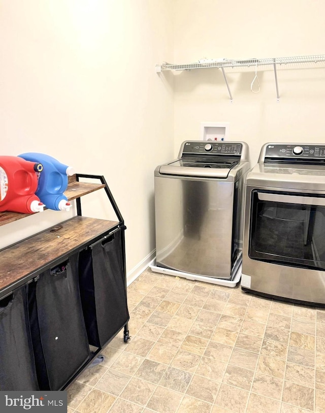 504 S Regulator Dr S, Cambridge, MD 21613 - laundry room featuring independent washer and dryer, baseboards, and stone finish floors