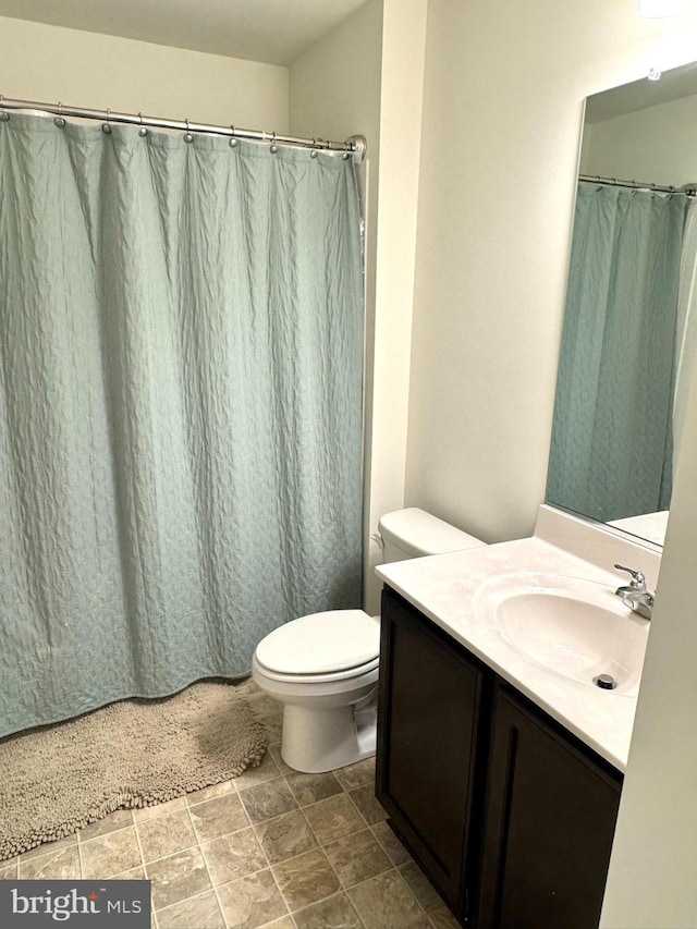 504 S Regulator Dr S, Cambridge, MD 21613 - bathroom with toilet, vanity, stone finish flooring, and a shower with curtain