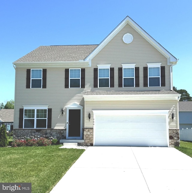 504 S Regulator Dr S, Cambridge, MD 21613 - view of front of home with stone siding, concrete driveway, a front lawn, and a garage