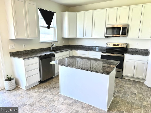 504 S Regulator Dr S, Cambridge, MD 21613 - kitchen featuring stainless steel appliances, a sink, white cabinets, and stone finish flooring