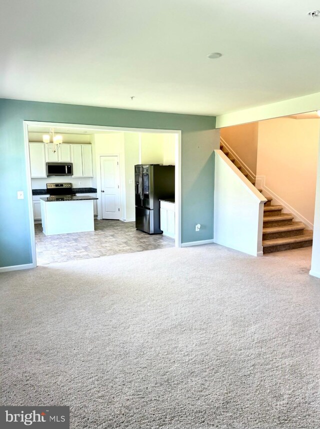 504 S Regulator Dr S, Cambridge, MD 21613 - unfurnished living room featuring baseboards, stairs, and light carpet