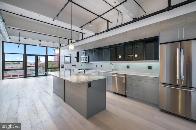 444 N 4th St Unit 415, Philadelphia, PA 19123 - kitchen featuring appliances with stainless steel finishes, a sink, modern cabinets, light wood-style flooring, and light countertops