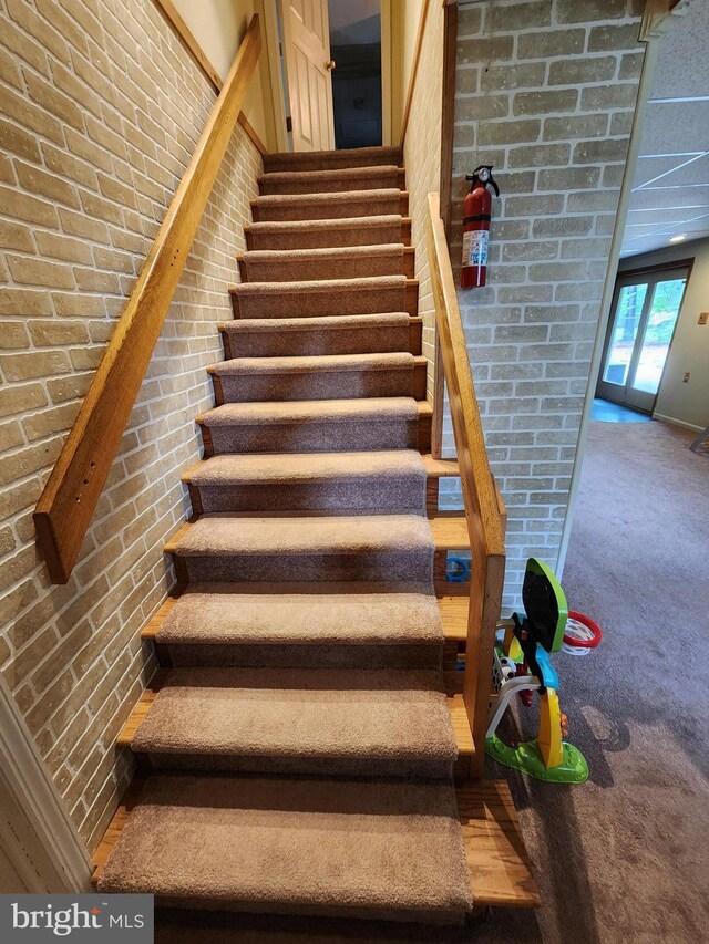 87 Summers St, Inwood, WV 25428 - staircase with brick wall and carpet