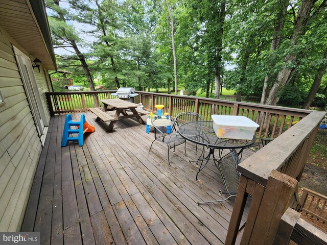 87 Summers St, Inwood, WV 25428 - wooden terrace featuring outdoor dining space, area for grilling, and view of wooded area