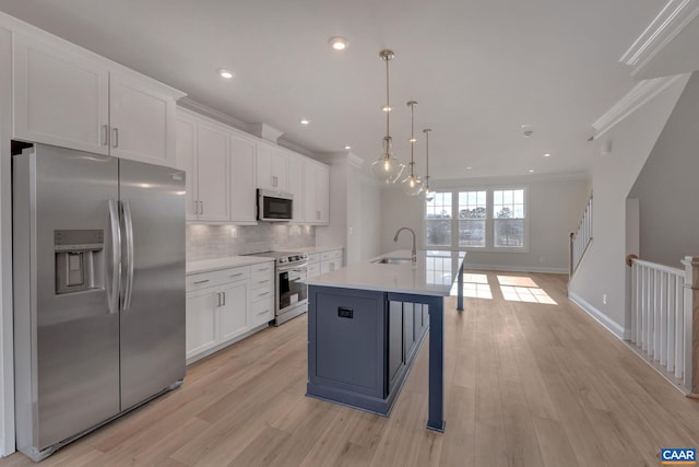 750 Park Ridge Dr, Crozet, VA 22932 - kitchen featuring stainless steel appliances, ornamental molding, white cabinetry, a sink, and light countertops