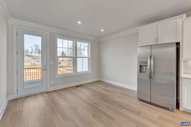 750 Park Ridge Dr, Crozet, VA 22932 - kitchen with stainless steel fridge, crown molding, light wood finished floors, baseboards, and white cabinets