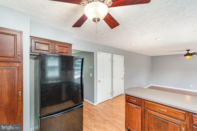 351 Point To Point Rd, Bel Air, MD 21015 - kitchen featuring freestanding refrigerator, a ceiling fan, a textured ceiling, light wood-style floors, and light countertops