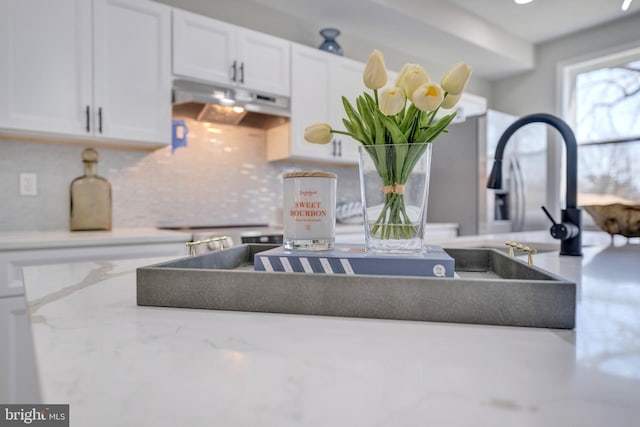 1121 48th Pl NE, Washington, DC 20019 - kitchen view of under cabinet range hood, white cabinets, and tasteful backsplash