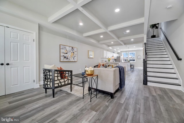 1121 48th Pl NE, Washington, DC 20019 - living room with light wood finished floors, coffered ceiling, beam ceiling, stairs, and baseboards