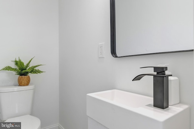 1121 48th Pl NE, Washington, DC 20019 - bathroom with toilet, vanity, and baseboards