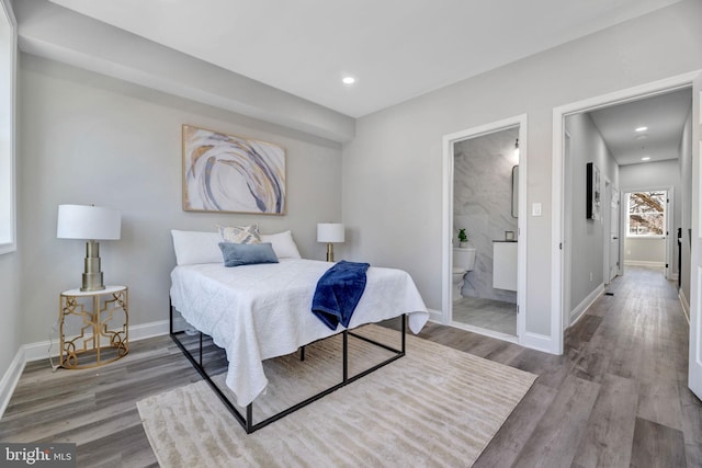 1121 48th Pl NE, Washington, DC 20019 - bedroom with wood finished floors, baseboards, ensuite bathroom, and recessed lighting