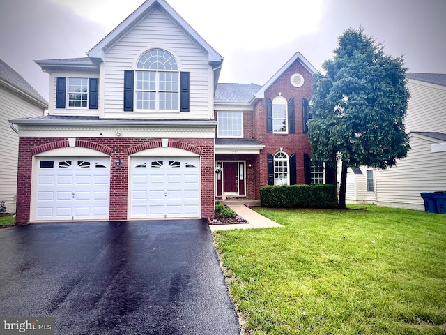 25487 Dabner Dr, Chantilly, VA 20152 - view of front facade featuring a front lawn, driveway, an attached garage, and brick siding