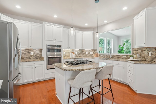 25487 Dabner Dr, Chantilly, VA 20152 - kitchen featuring stainless steel appliances, a sink, decorative backsplash, light wood finished floors, and recessed lighting