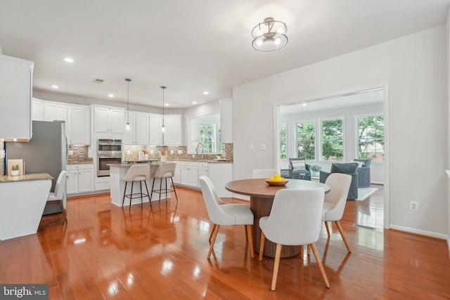 25487 Dabner Dr, Chantilly, VA 20152 - dining room featuring light wood-type flooring, recessed lighting, and baseboards