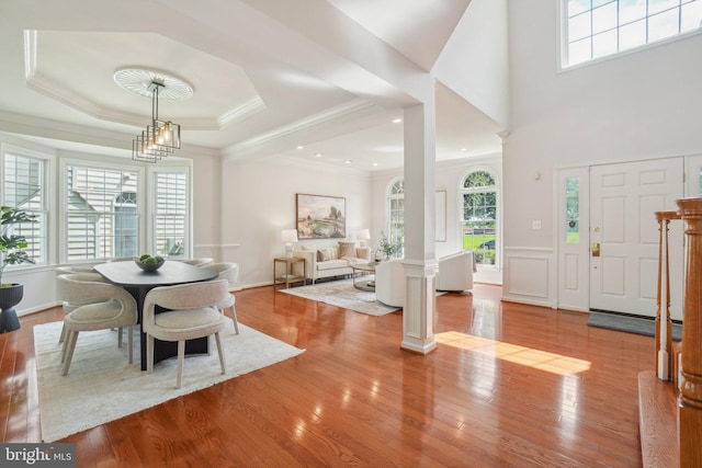 25487 Dabner Dr, Chantilly, VA 20152 - dining room featuring healthy amount of natural light, ornate columns, wood finished floors, and ornamental molding