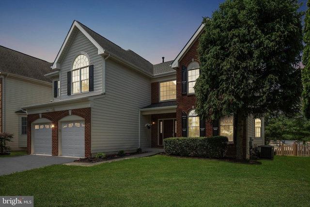 25487 Dabner Dr, Chantilly, VA 20152 - traditional-style home featuring an attached garage, central air condition unit, brick siding, and driveway