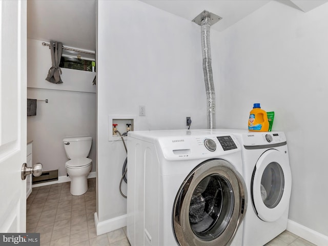 4024 Roop Rd, New Windsor, MD 21776 - washroom featuring washer and clothes dryer, baseboards, and light tile patterned floors