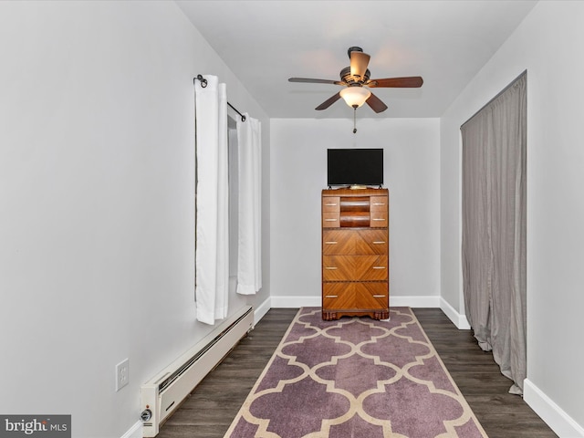 4024 Roop Rd, New Windsor, MD 21776 - spare room with a baseboard radiator, baseboards, a ceiling fan, and dark wood-style floors