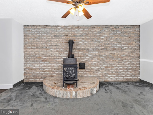 4024 Roop Rd, New Windsor, MD 21776 - detailed view of baseboards, carpet, brick wall, ceiling fan, and a wood stove