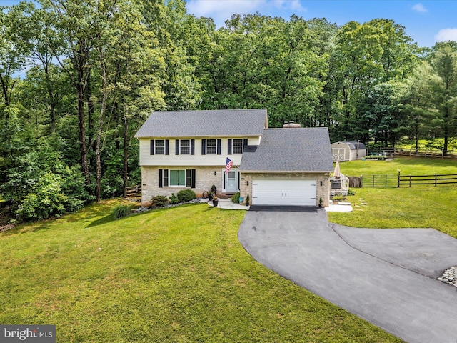 4024 Roop Rd, New Windsor, MD 21776 - colonial home featuring asphalt driveway, roof with shingles, an attached garage, and brick siding