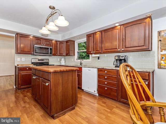 4024 Roop Rd, New Windsor, MD 21776 - kitchen featuring stainless steel appliances, butcher block countertops, light wood finished floors, tasteful backsplash, and a sink