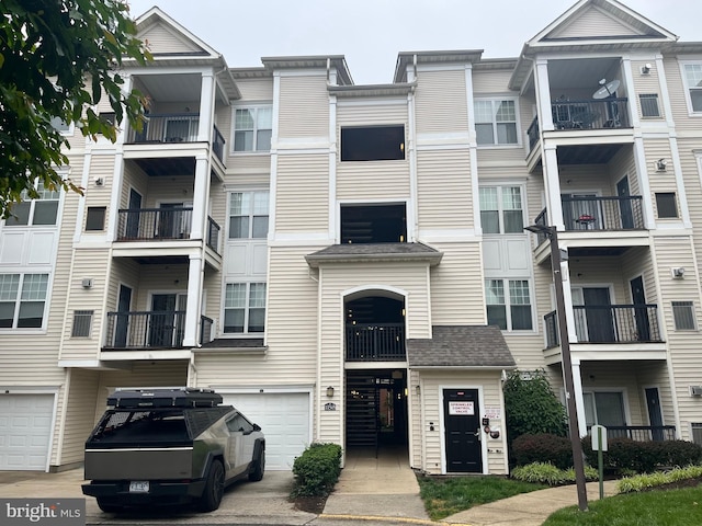 11345 Aristotle Dr Unit 6-311, Fairfax, VA 22030 - view of building exterior featuring a garage