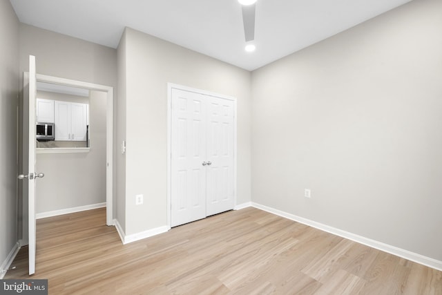 11345 Aristotle Dr Unit 6-311, Fairfax, VA 22030 - unfurnished bedroom with light wood-style flooring, baseboards, a closet, and recessed lighting
