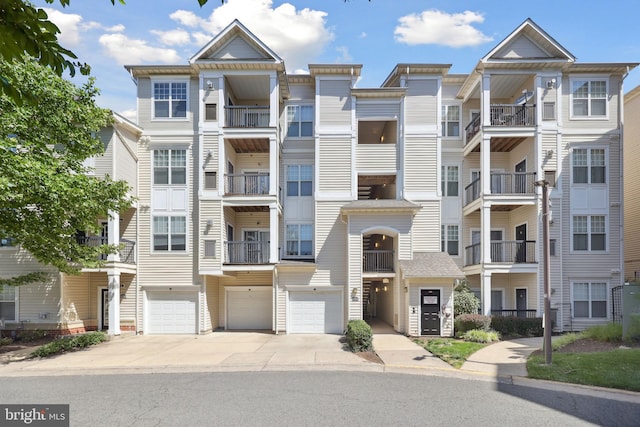 11345 Aristotle Dr Unit 6-311, Fairfax, VA 22030 - view of building exterior with driveway and a garage