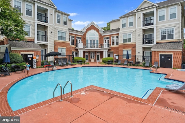 11345 Aristotle Dr Unit 6-311, Fairfax, VA 22030 - community pool featuring a patio