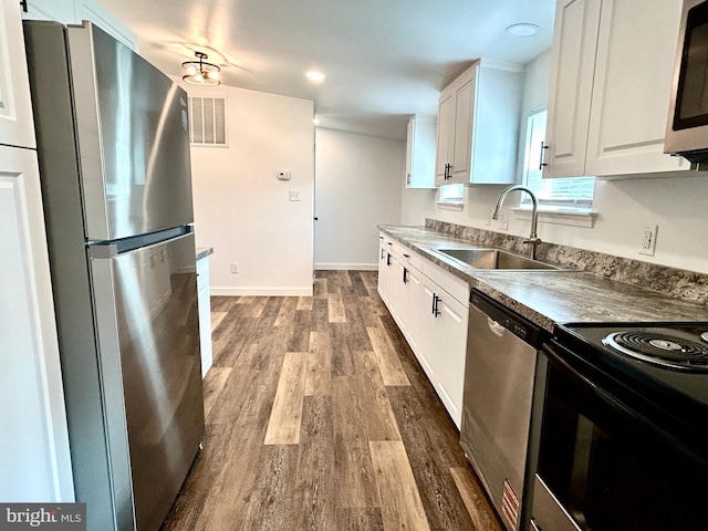 135 Crawford Quarry Rd, Falling Waters, WV 25419 - kitchen with stainless steel appliances, a sink, white cabinetry, dark wood finished floors, and baseboards