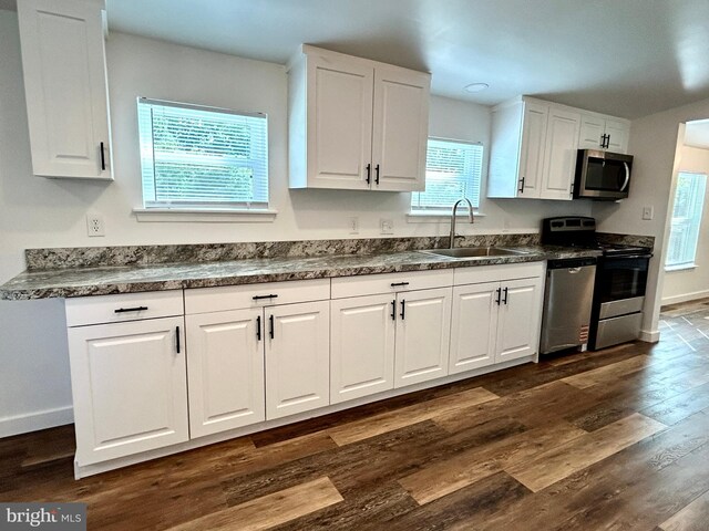 135 Crawford Quarry Rd, Falling Waters, WV 25419 - kitchen featuring stainless steel appliances, a sink, white cabinetry, and dark countertops