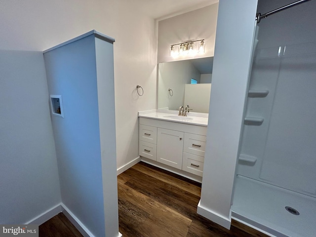 135 Crawford Quarry Rd, Falling Waters, WV 25419 - bathroom featuring vanity, wood finished floors, a shower, and baseboards