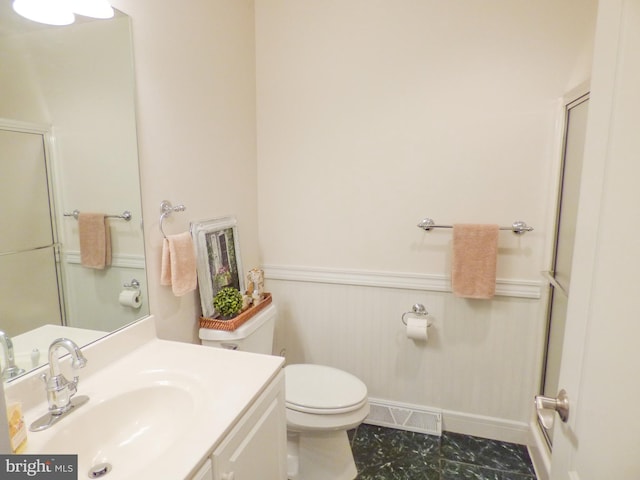 2543 Fairway Dr Unit 2543, York, PA 17402 - bathroom featuring toilet, a shower with shower door, vanity, and wainscoting