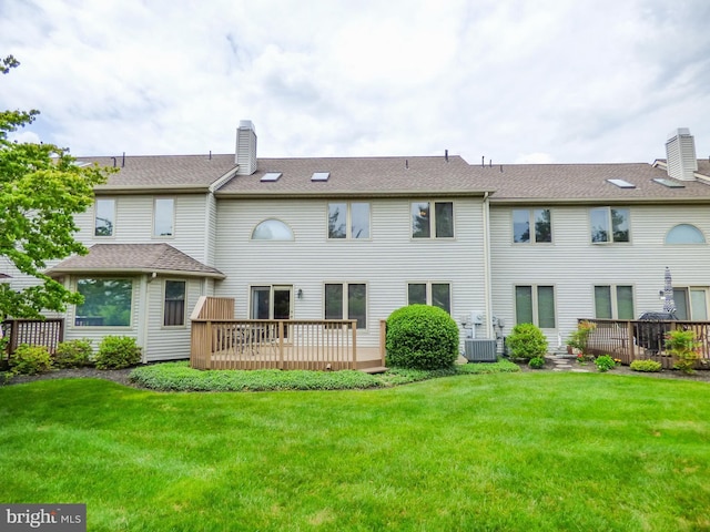 2543 Fairway Dr Unit 2543, York, PA 17402 - rear view of property featuring a deck, a chimney, central AC, and a lawn