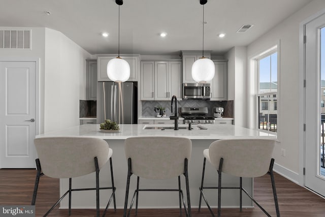 43294 Farringdon Sq, Broadlands, VA 20148 - kitchen featuring appliances with stainless steel finishes, tasteful backsplash, light countertops, a sink, and recessed lighting