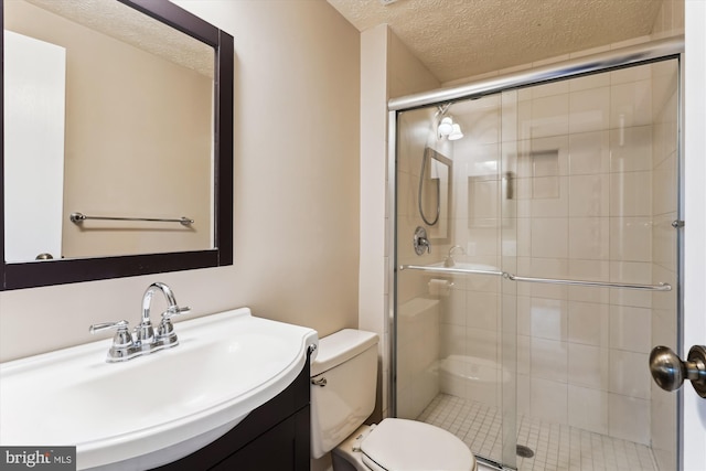 9175 Forest Lawn Ct, Springfield, VA 22152 - bathroom featuring a textured ceiling, toilet, vanity, and a stall shower