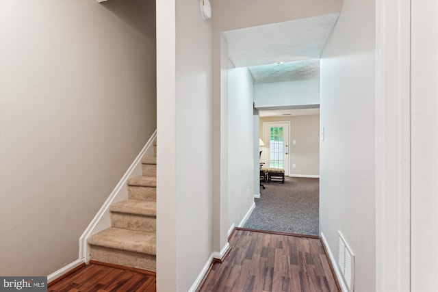 9175 Forest Lawn Ct, Springfield, VA 22152 - hall featuring baseboards, dark wood-type flooring, and stairway