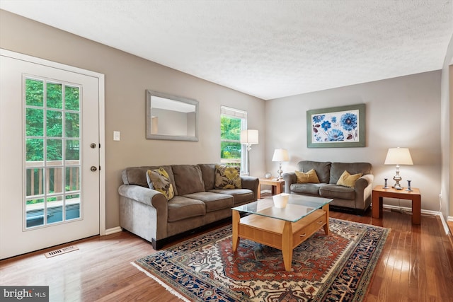 9175 Forest Lawn Ct, Springfield, VA 22152 - living room with wood finished floors, a textured ceiling, and baseboards