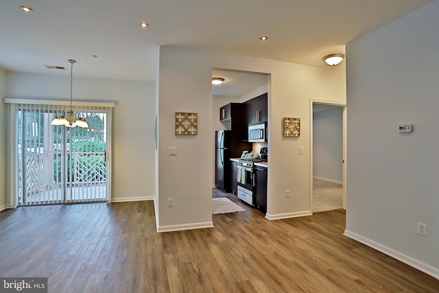 5909 Founders Hill Dr Unit 101, Alexandria, VA 22310 - kitchen with appliances with stainless steel finishes, dark wood finished floors, a chandelier, baseboards, and pendant lighting