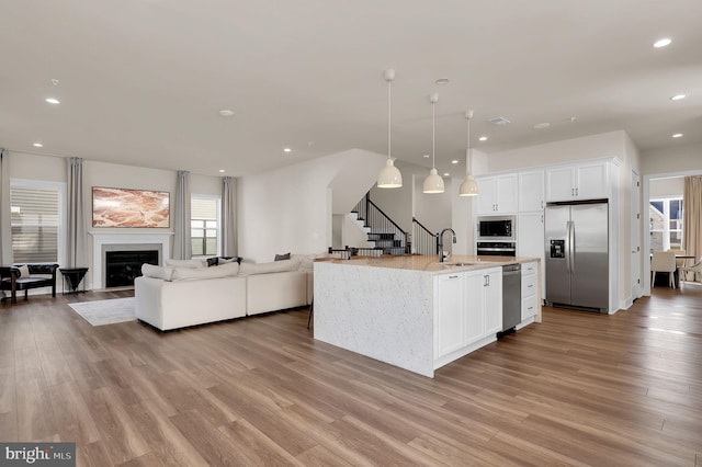 14009 Kip Ter, North Potomac, MD 20878 - kitchen with stainless steel appliances, open floor plan, a sink, light wood-style flooring, and recessed lighting
