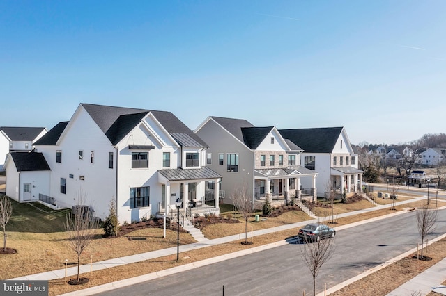 14009 Kip Ter, North Potomac, MD 20878 - view of front of house featuring a standing seam roof, a residential view, a porch, and metal roof