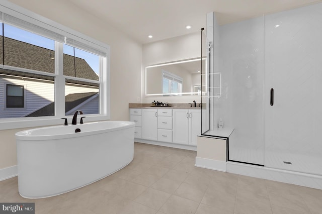 14009 Kip Ter, North Potomac, MD 20878 - bathroom with vanity, a soaking tub, a stall shower, tile patterned flooring, and recessed lighting